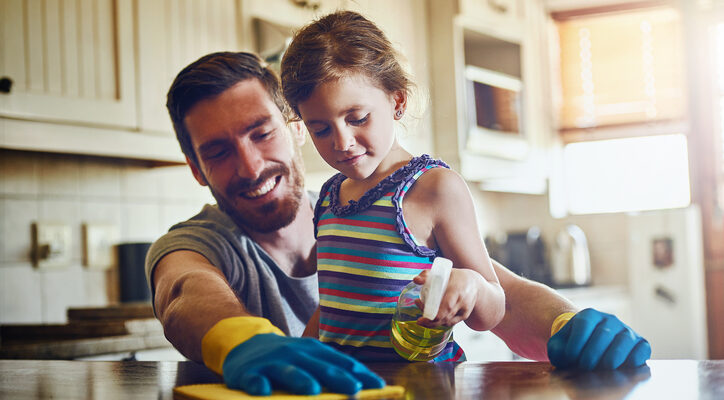 Cropped shot of a father and his little daughter cleaning a kitchen surface together at home
